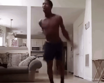 Shirtless Man Dancing in Living Room