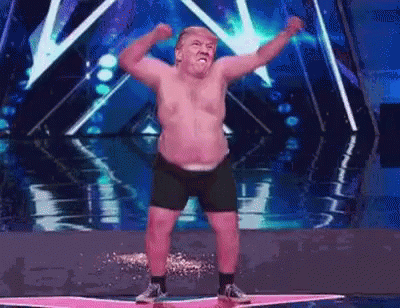 Shirtless Man Dancing on Stage Arms Up