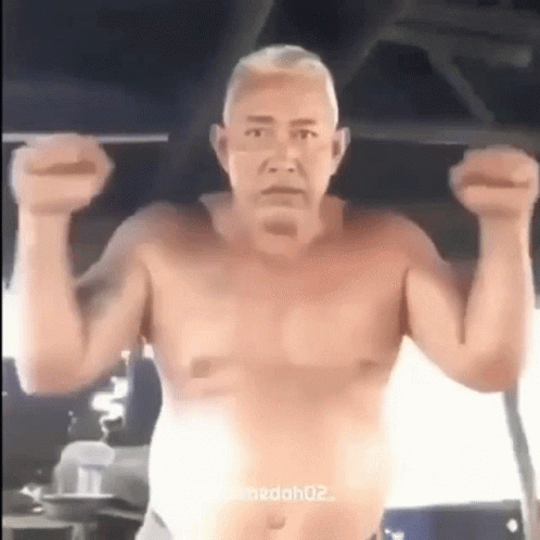 Shirtless Man Doing Pull Ups In Gym With Arms In Air GIF