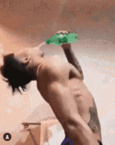Shirtless Man Drinking Green Bottle