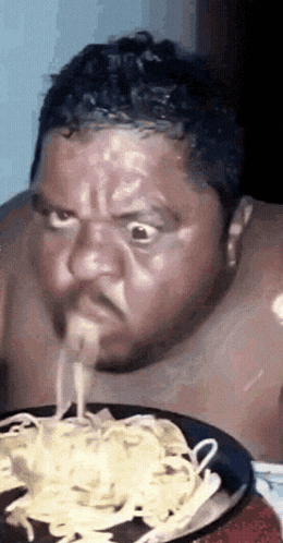 Shirtless Man Eating Spaghetti