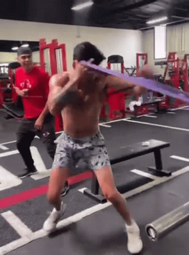 Shirtless Man Exercising With Resistance Band