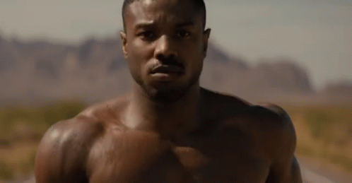 Shirtless Man Faces Camera Desert GIF