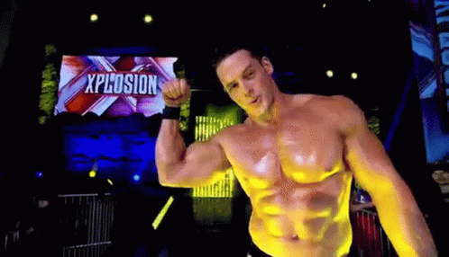 Shirtless Man Flexing Muscles on Stage