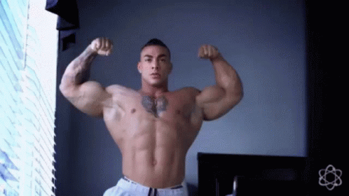 Shirtless Man Flexing Muscles With Chest Tattoo GIF