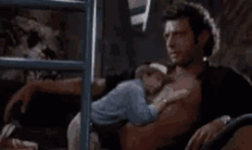 Shirtless Man Holding Baby On Bed GIF