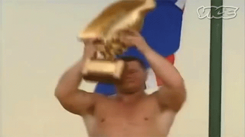 Shirtless Man Holding Gold Trophy GIF
