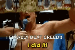 Shirtless Man Holding Microphone Says I Finally Beat Creed