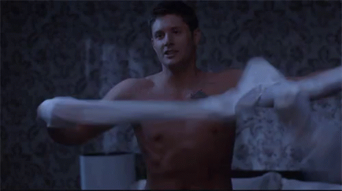 Shirtless Man Holding Pillow Over Head On Bed GIF