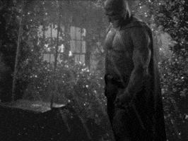 Shirtless Man In Batman Costume In Dark Room GIF