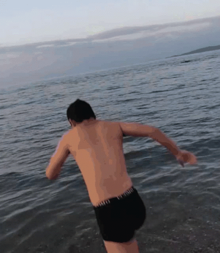 Shirtless Man In Black Shorts Jumping Into Water GIF