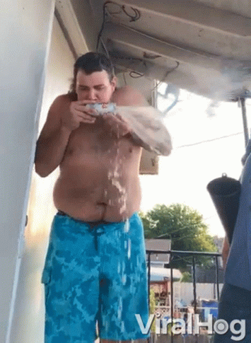 Shirtless Man In Blue Shorts Drinking Water GIF
