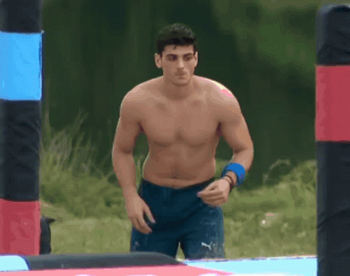 Shirtless Man in Blue Shorts Walking Maze