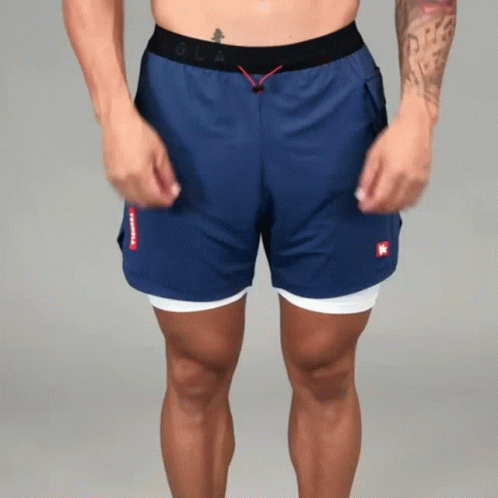 Shirtless Man in Blue Shorts With Red K