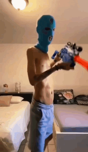 Shirtless Man in Blue Ski Mask Holding Water Gun