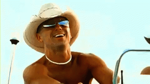 Shirtless Man in Cowboy Hat Smiling on Boat