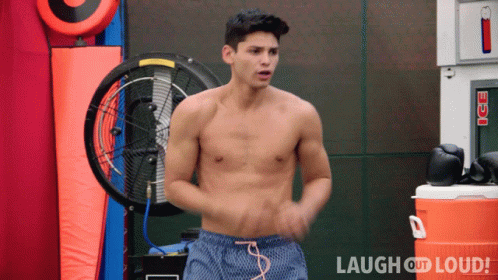 Shirtless Man in Front of Ice Machine and Fan