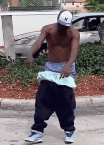 Shirtless Man in Hurley Hat Dancing