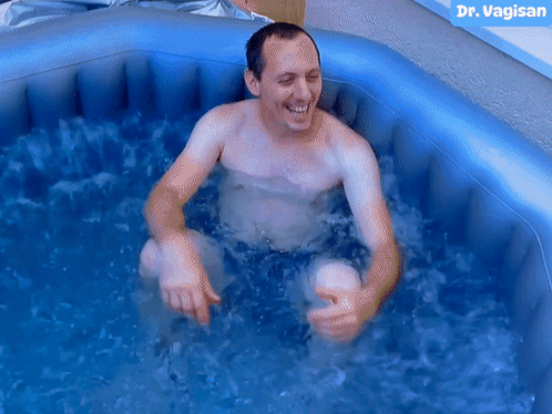Shirtless Man in Inflatable Pool With Dr Vaginan