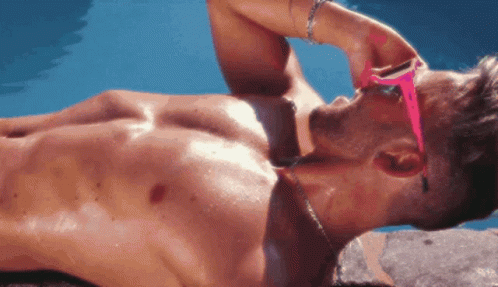 Shirtless Man in Pink Sunglasses Lying on Beach