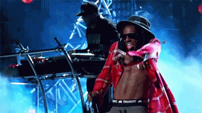 Shirtless Man in Plaid Shirt Standing Before DJ