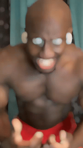 Shirtless Man in Red Shorts