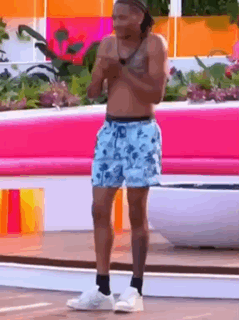 Shirtless Man in Shorts at Pink Bench