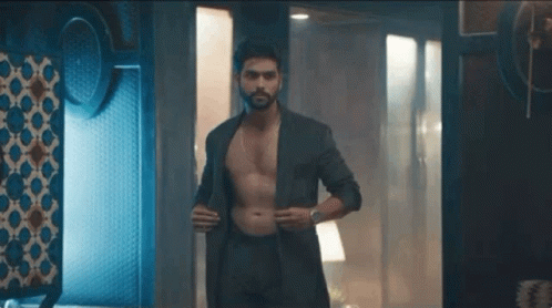 Shirtless Man in Suit and Underwear Standing in Dark Room