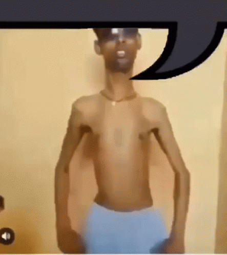 Shirtless Man in Sunglasses and Blue Shorts