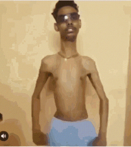 Shirtless Man in Sunglasses and Blue Shorts