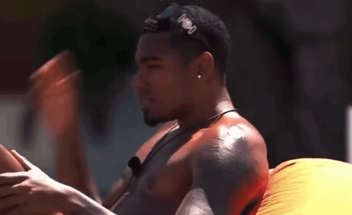 Shirtless Man in Sunglasses on Inflatable Raft