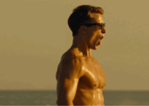 Shirtless Man In Sunglasses Screaming On Beach GIF