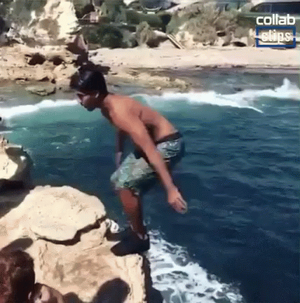 Shirtless Man Jumping Into Ocean