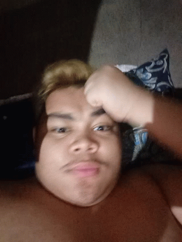 Shirtless Man Laying on Bed With Blue and White Pillow