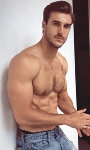 Shirtless Man Leaning Against Wall