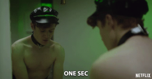 Shirtless Man Looking in Mirror With One Sec