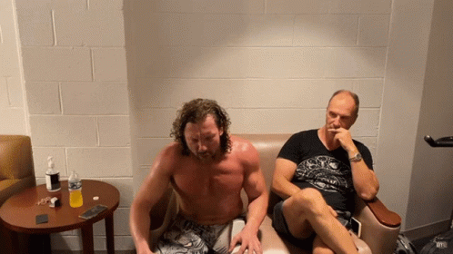 Shirtless Man Next to Another Man on Couch