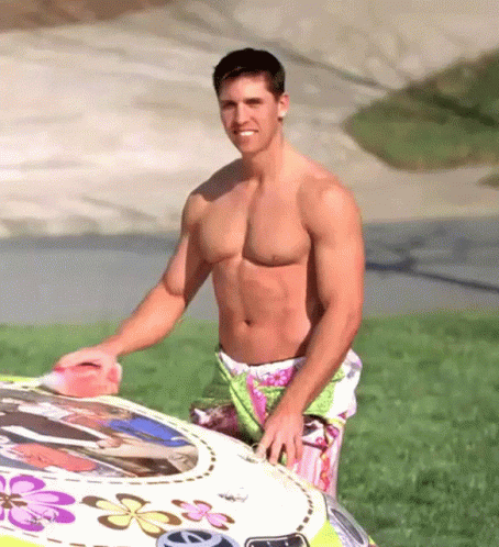Shirtless Man Next To Car With Flowers GIF