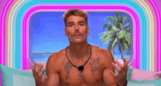 Shirtless Man on Couch With Hands Up Before Rainbow
