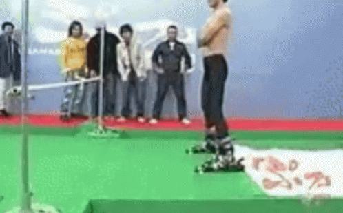 Shirtless Man on Green Carpet With Crowd