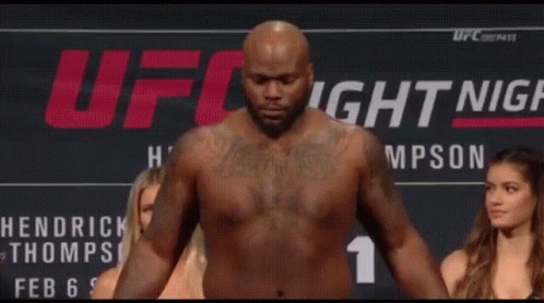Shirtless Man On Scale With Two Women Watching GIF