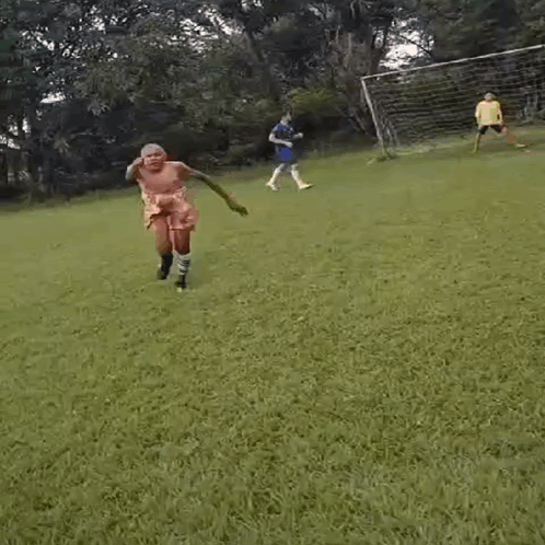 Shirtless Man on Soccer Field in Shorts and Socks