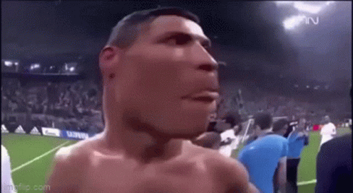 Shirtless Man on Soccer Field With Crowd