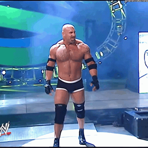 Shirtless Man on Stage in Front of WWE Sign