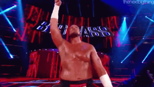 Shirtless Man On Stage With Arm Raised GIF