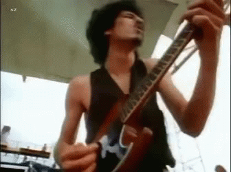Shirtless Man Playing Guitar On Stage GIF