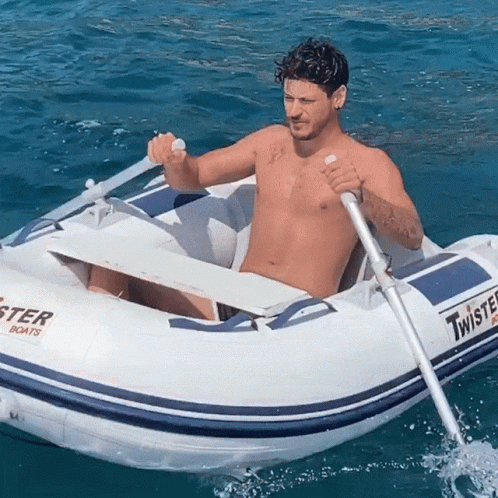 Shirtless Man Rowing Twister Boat In Ocean GIF
