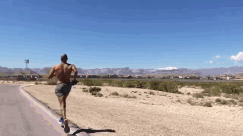 Shirtless Man Running in Desert
