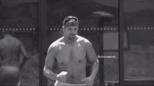 Shirtless Man Running in Front of Glass Door