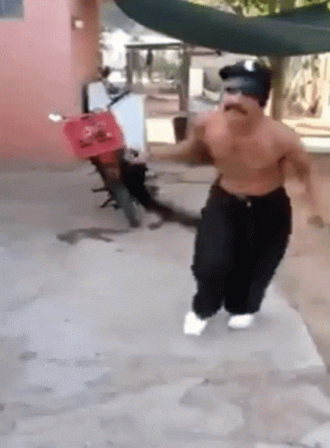 Shirtless Man Running In Front Of Red Scooter GIF
